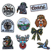 A collection of embroidered hunting patches and badges featuring various animals, including a dog, bird, and a fox-like face.
