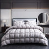 A luxurious white goose down duvet with a cotton cover displayed on a bed in a modern bedroom.