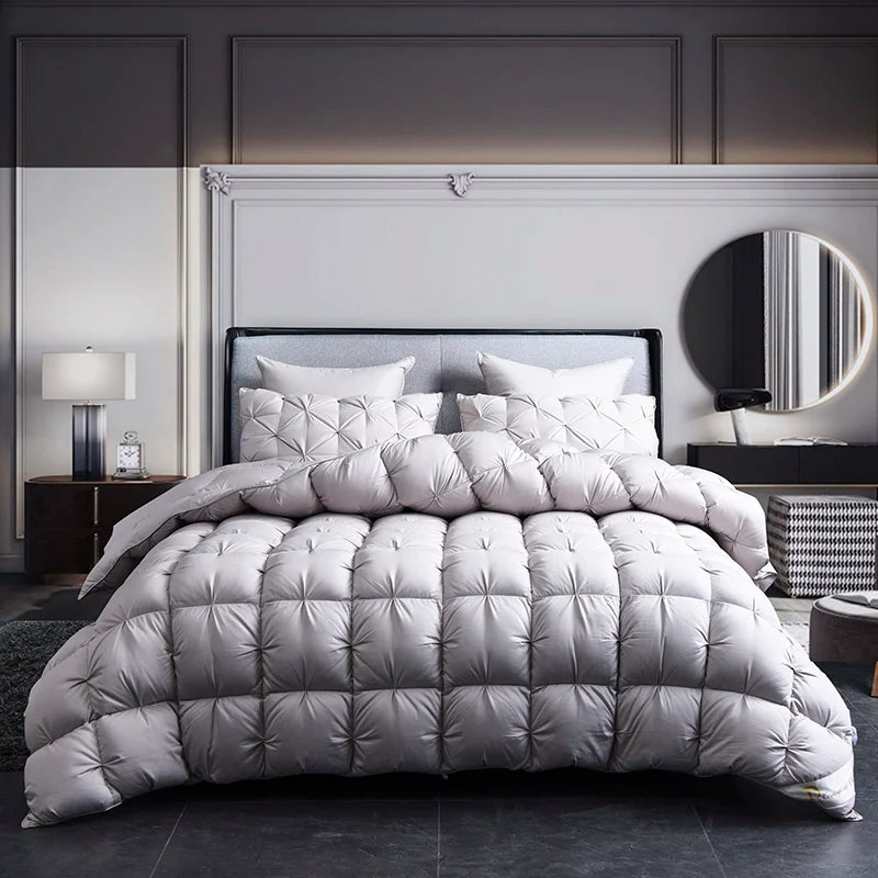 A luxurious white goose down duvet with a cotton cover displayed on a bed in a modern bedroom.