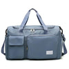 A light blue travel duffel bag with a top handle and a front pocket for shoes.