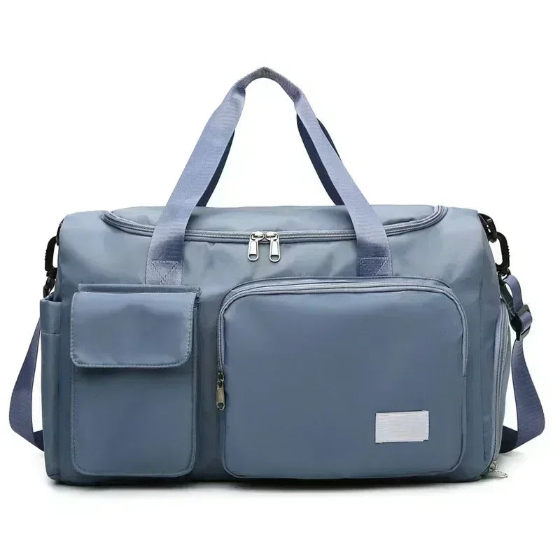 A light blue travel duffel bag with a top handle and a front pocket for shoes.