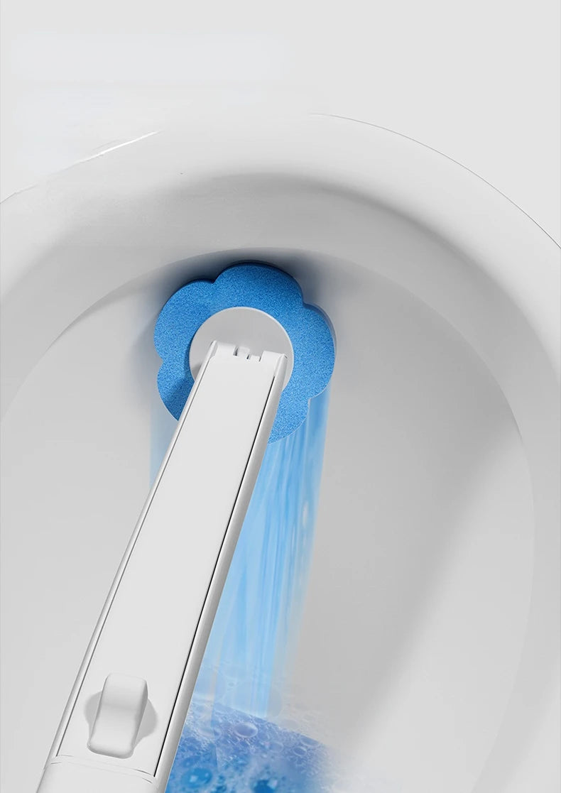 A white wall-mounted holder for a blue disposable toilet brush is shown pouring water into the toilet bowl.