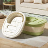 A white foldable foot bath tub with a lid is shown next to a light green storage container on a wooden surface.