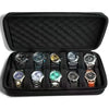 A black portable leather watch travel case with soft lining containing several wristwatches.