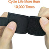 A hand holds a black heavy-duty nylon cord organizer strap with a triangle buckle.
