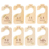 A set of wooden baby closet dividers with size labels for newborn to toddler months