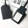 A black PU leather luggage tag with a rectangular design and a white name and address section.
