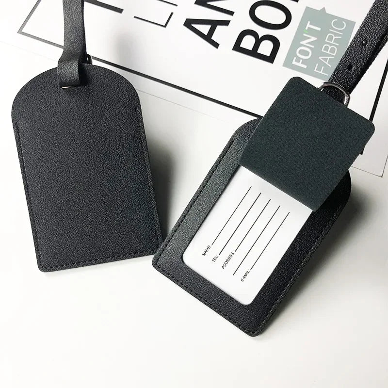 A black PU leather luggage tag with a rectangular design and a white name and address section.