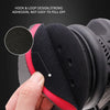 A hand is holding a black and red reusable magic clay pad for paint detailing, showing its hook and loop design.