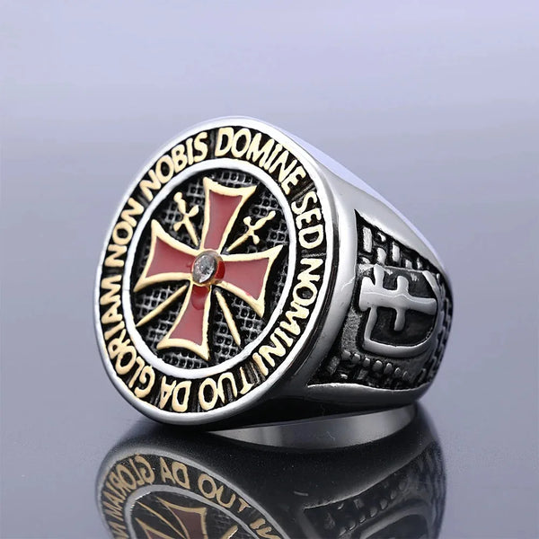 A silver signet ring featuring a cross design engraved with Latin text on the bezel.