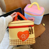 A yellow insulated lunch bag with a heart design and a checkered pattern is shown next to a pink and blue patterned lunch box