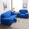 A bright blue silky soft stretchable sofa cover displayed on a sofa and armchair in a well-lit room.