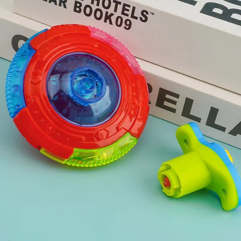 A red and blue glowing musical spinning top is shown next to a yellow and blue plastic toy.