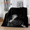 A black throw blanket featuring a silhouette of Eminem and 2Pac.