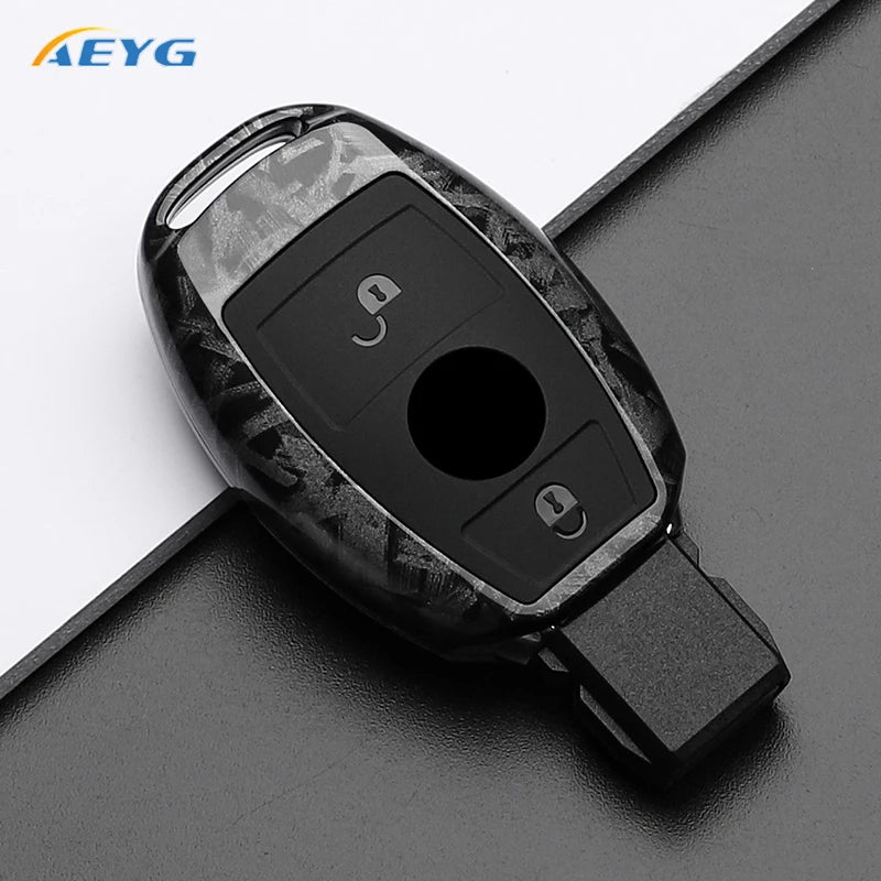 A black slim carbon fiber car key cover with a cutout for the key and two small openings.