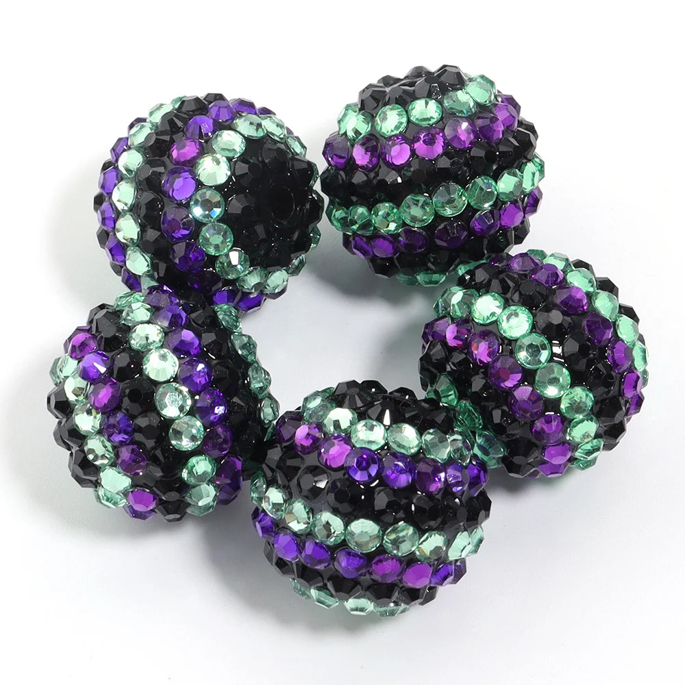 A set of five resin rhinestone beads with a two-tone striped design in purple and green.