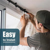 A man installs a flexible bendable curtain track system on a ceiling using a mounting bracket.