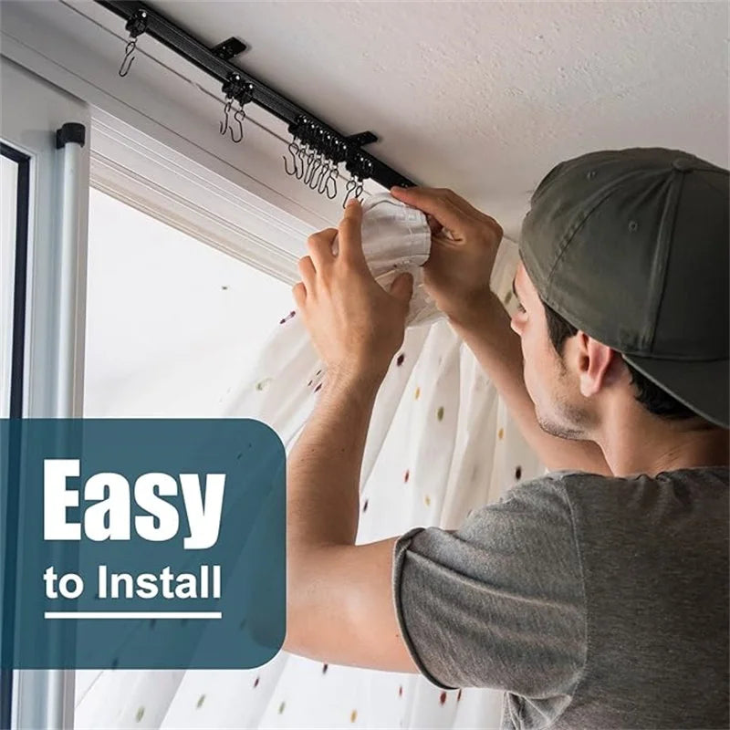 A man installs a flexible bendable curtain track system on a ceiling using a mounting bracket.