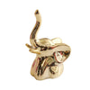 Gold-toned ceramic elephant and rabbit jewelry holder with a curved horn design.