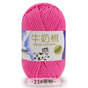 Pink milk cotton blend yarn skein with a label featuring a dog and stitching details