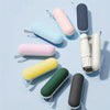 A collection of colorful compact folding umbrellas in various pastel and muted tones arranged on a light blue background.