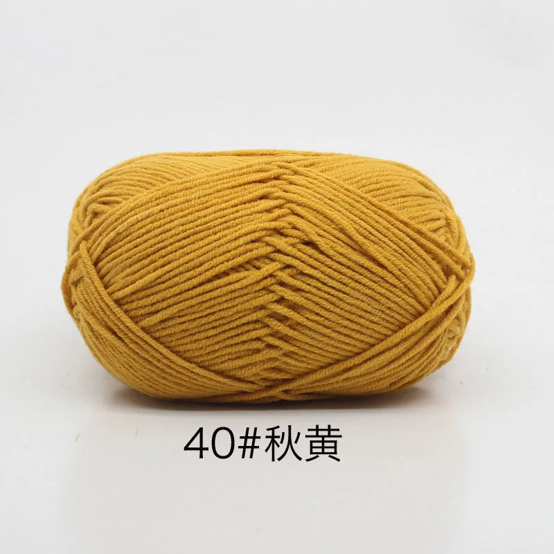 A ball of golden yellow 4-ply milk cotton yarn for knitting and crochet.