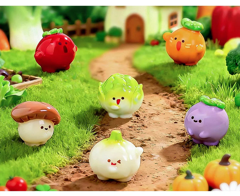 A collection of hand-painted resin vegetable figurines, including a strawberry, pumpkin, mushroom, and various green and yell