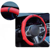 A close-up view of a red perforated leather steering wheel cover with a black accent on a car's steering wheel.