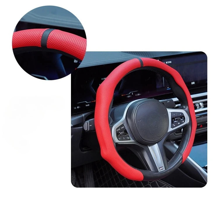 A close-up view of a red perforated leather steering wheel cover with a black accent on a car's steering wheel.