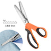 Orange and black professional pinking shears with stainless steel blades shown next to a piece of fabric