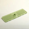 A silicone faucet draining mat in light green with raised ridges and a raised edge.
