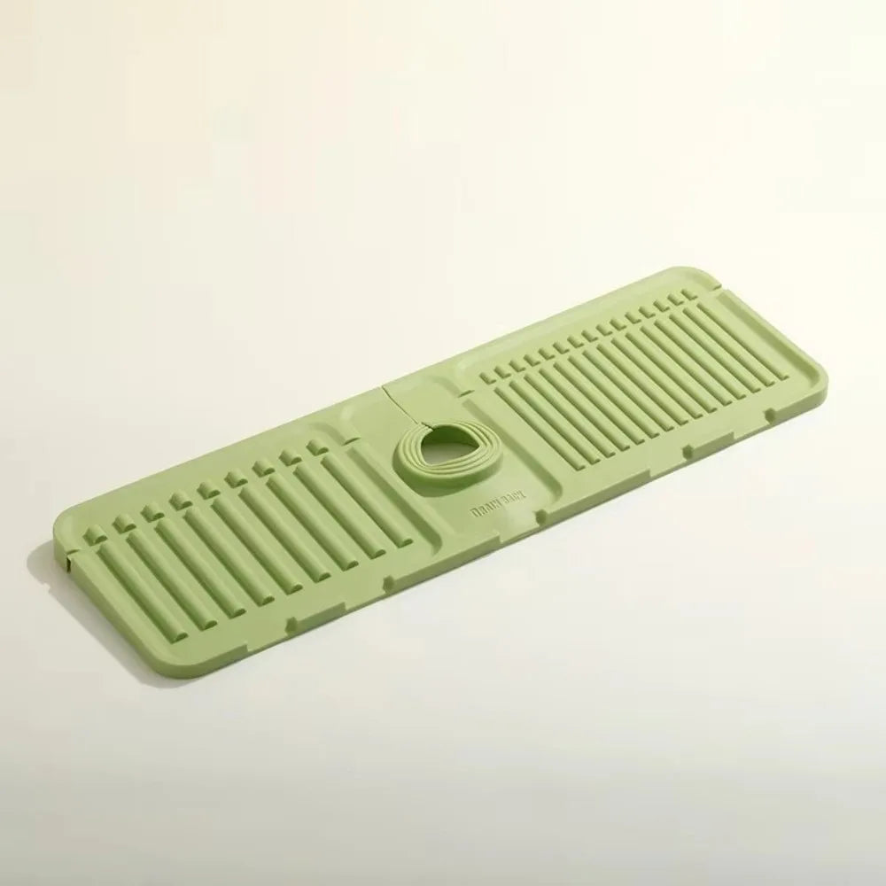 A silicone faucet draining mat in light green with raised ridges and a raised edge.