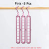 Three pink folding hangers with 9 holes are displayed hanging on a wooden rod.