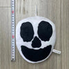A round black and white face plush toy resembling Opila Bird from Garten of BanBan