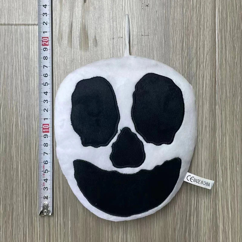 A round black and white face plush toy resembling Opila Bird from Garten of BanBan
