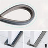 A close-up view of a gray door and window sealing strip used for draft proofing.