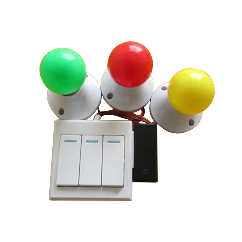 A kit of three colored spinning balls (green, red, yellow) mounted on a white base with switches.