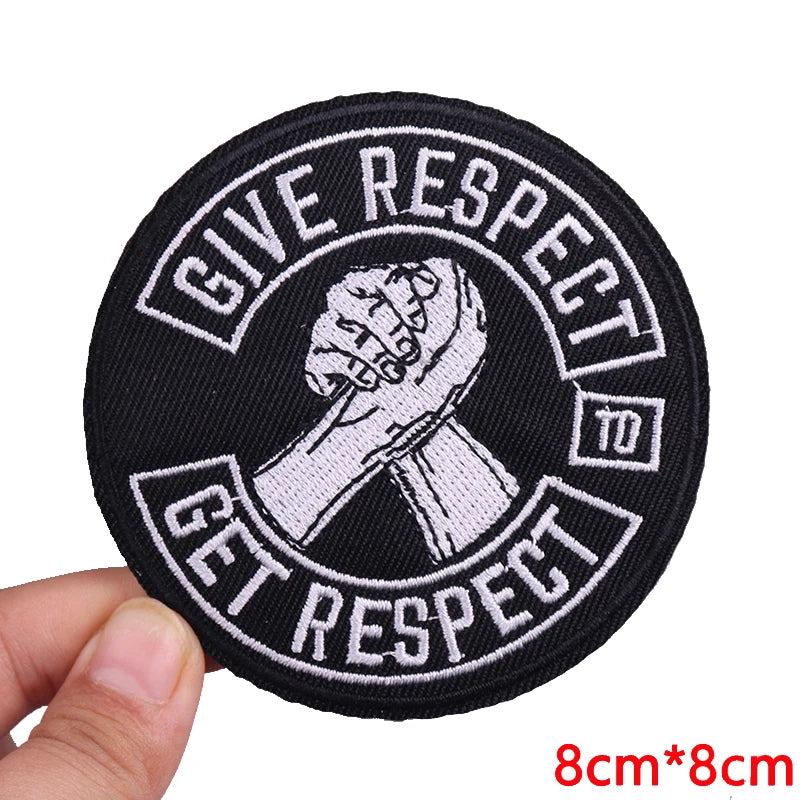 Black embroidered iron-on letter patch with white text that reads Give Respect to Get Respect