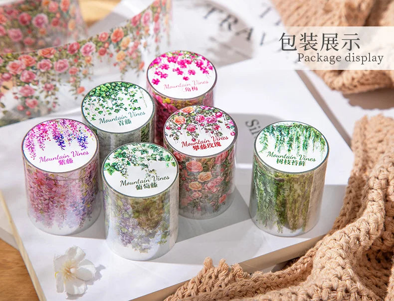 A display of various colored Mountain Vines decorative PET tape rolls for journaling and crafts.