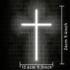 A bright white LED Jesus cross neon sign mounted on a dark brick wall.