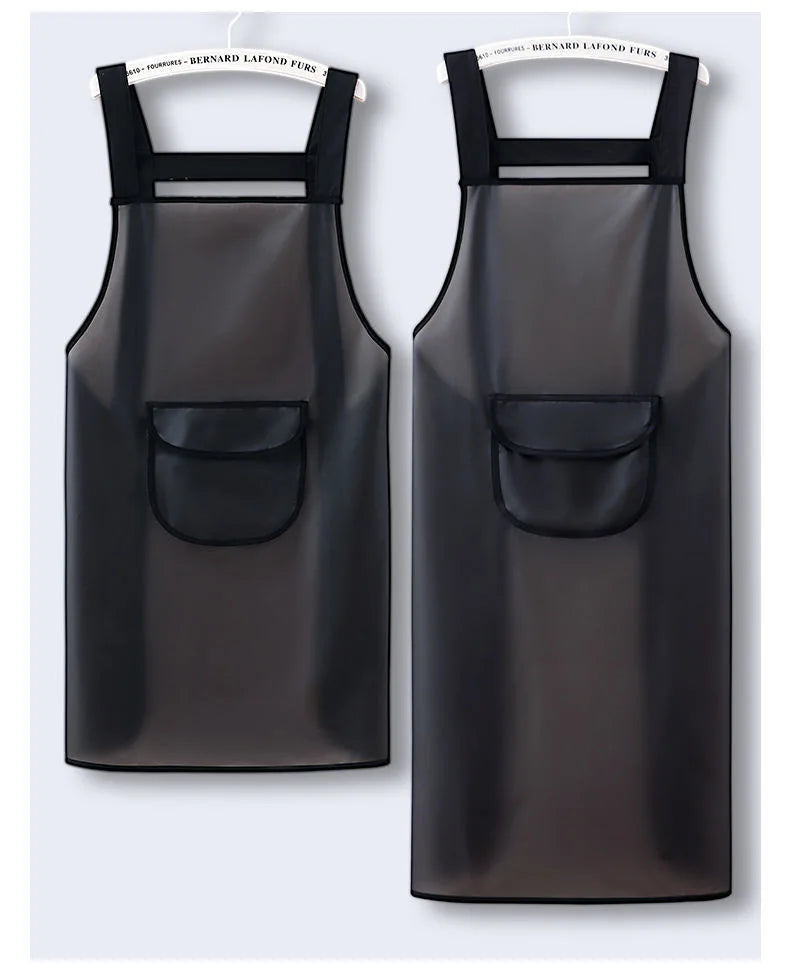 A black waterproof kitchen apron hanging on a hanger.