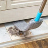 A telescopic microfiber duster brush with a blue handle is shown cleaning dust from a window sill.