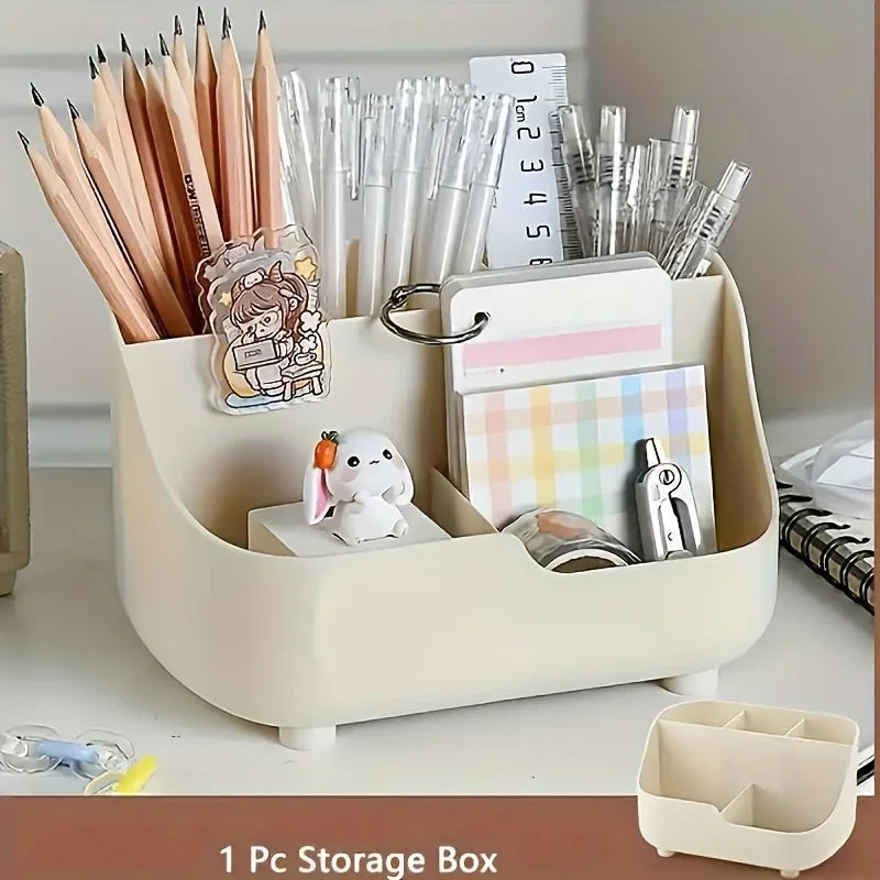 A beige storage box filled with various pens, pencils, and desk supplies including a small white animal figurine.