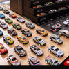 A collection of 48 diecast metal cars displayed on a wooden surface.