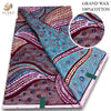 A close-up view of pink glitter African wax print fabric in various patterns and colors