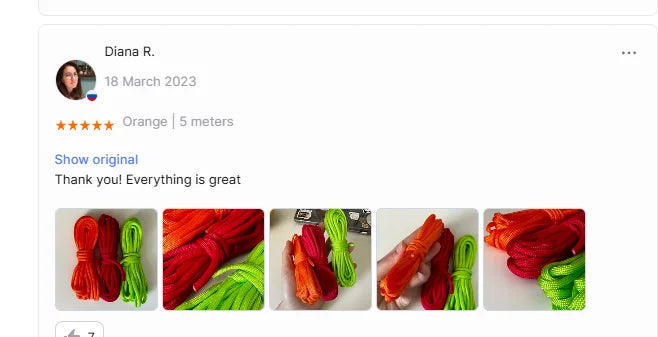 A collection of brightly colored paracord ropes in red, orange, green, and yellow are displayed on a white background.