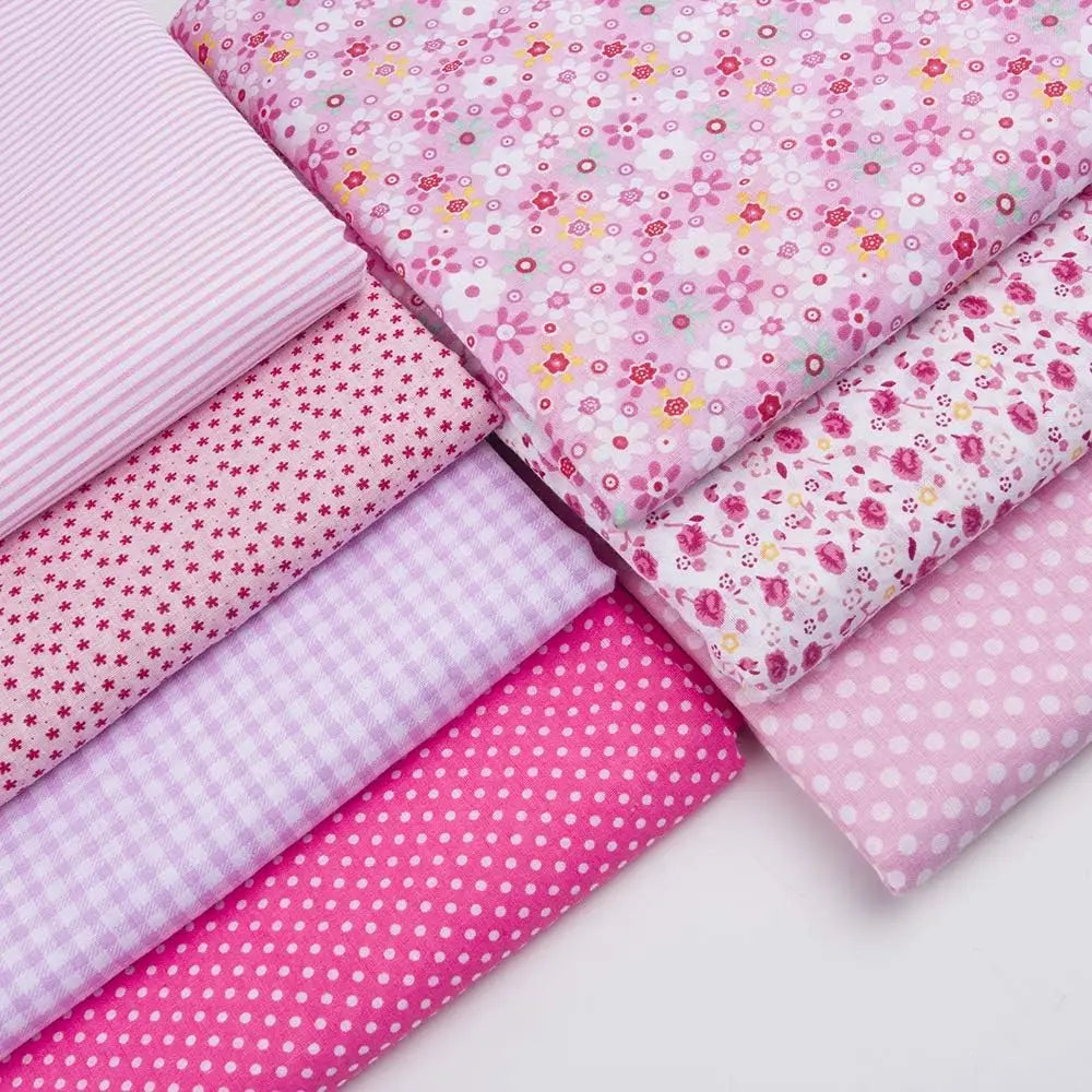 A collection of pink cotton quilted fabric strips featuring various floral and polka dot patterns.
