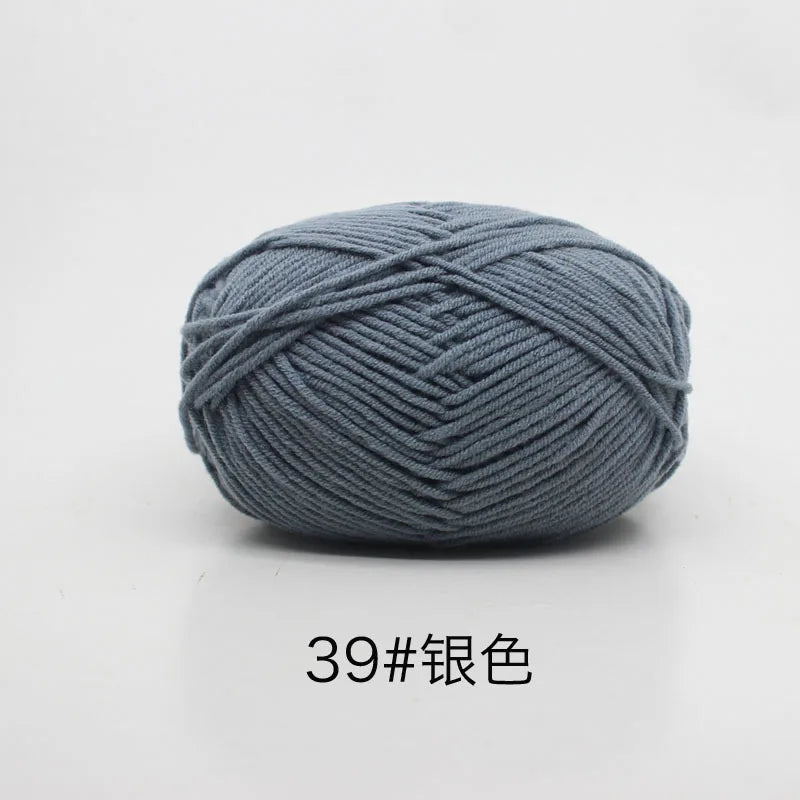A ball of gray 4-ply milk cotton yarn for knitting and crochet.