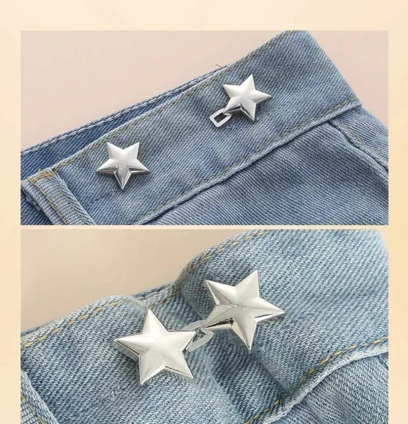 Silver star-shaped metal brooch belt buckle pinned onto a blue denim fabric.
