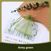 Army green organza drawstring jewelry gift bags with dried greenery displayed on a wooden surface.